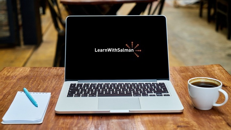 06-Cisco_Data_Centers-ACI_Automation_With_Ansible A laptop displaying LearnWithSalman on the screen is centered on a wooden table. To the left of the laptop is a spiral notebook with a pen, and to the right is a white cup filled with black coffee. The background features blurred wooden flooring and furniture.